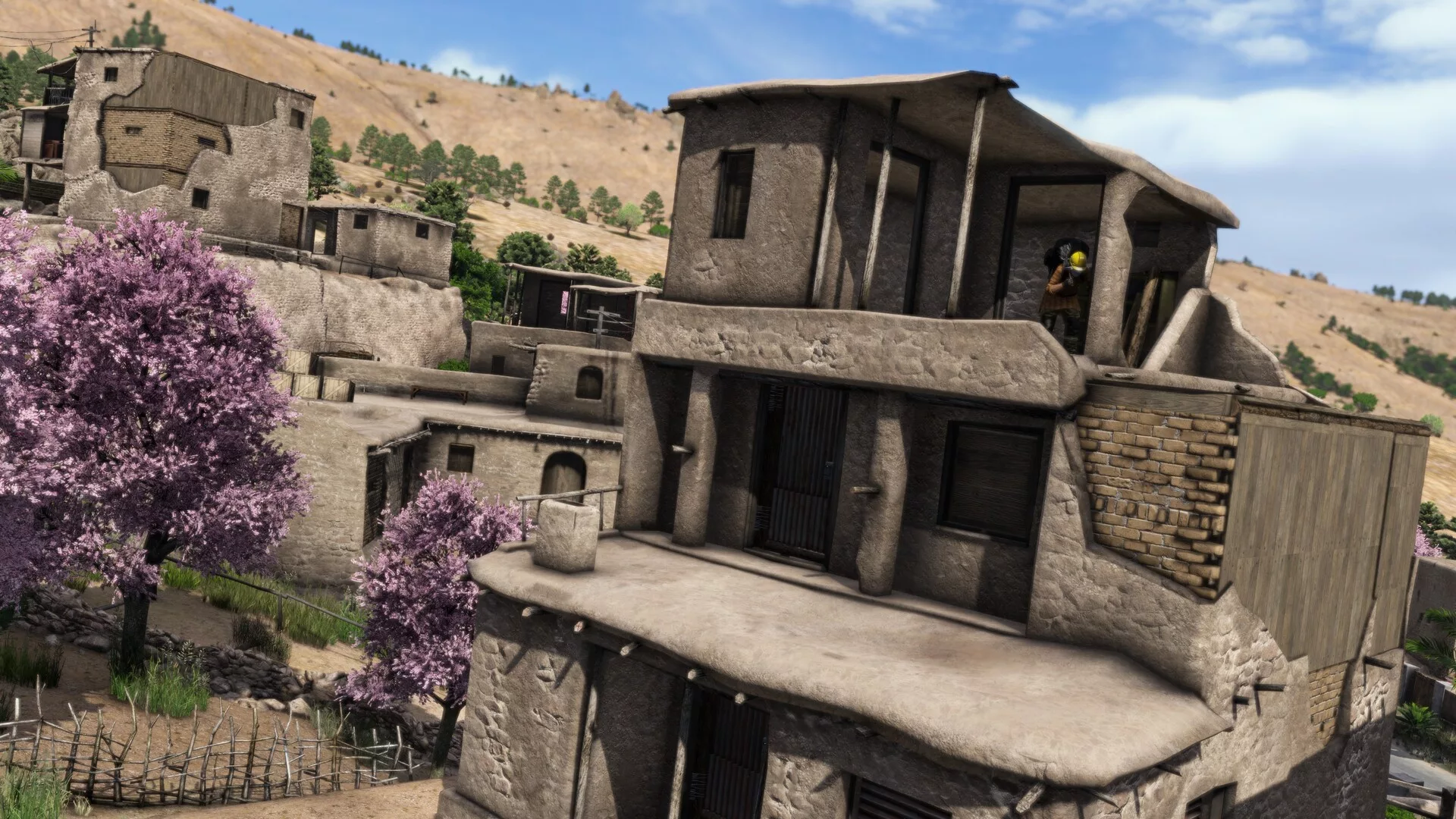 Casas de pedra e adobe numa encosta de Nasdara, em DayZ Badlands